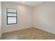 Well-lit bedroom featuring tile floors, neutral walls, and a window with blinds at 309 Potenza Loop, Nokomis, FL 34275