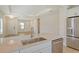 Open floor plan from kitchen island with sink looking to the front door and living area at 309 Potenza Loop, Nokomis, FL 34275