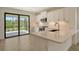 Modern kitchen with white cabinets, quartz countertops, and stainless steel appliances at 309 Potenza Loop, Nokomis, FL 34275