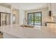 This modern kitchen has quartz countertops, stainless appliances, and a large sliding glass door to the patio at 309 Potenza Loop, Nokomis, FL 34275