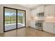 This bright kitchen has stainless appliances, a tile backsplash, and a pass-through to the lanai at 309 Potenza Loop, Nokomis, FL 34275