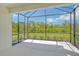 Screened patio featuring views of a lush green yard and wooded area at 309 Potenza Loop, Nokomis, FL 34275