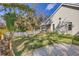 Spacious backyard with white picket fence, manicured lawn, and screened-in porch at 3301 River Woods Dr, Parrish, FL 34219