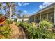 Beautifully landscaped backyard with stone pathway leading to a screened patio at 3301 River Woods Dr, Parrish, FL 34219