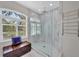 Shower with frameless door features custom tile and natural light at 3301 River Woods Dr, Parrish, FL 34219