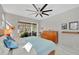 Bedroom features a slider to lanai, neutral decor, and wood dresser at 3301 River Woods Dr, Parrish, FL 34219