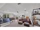 Spacious bonus room features workout equipment and a lounge area with leather sofas at 3301 River Woods Dr, Parrish, FL 34219