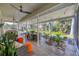 Covered patio with tile flooring, ceiling fans, and outdoor seating overlooking the backyard at 3301 River Woods Dr, Parrish, FL 34219