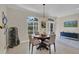 Dining area with elegant chandelier, large windows, and easy access to the home's entrance at 3301 River Woods Dr, Parrish, FL 34219