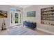 Foyer with a view of the outside, adorned with stylish art and a cabinet with sleek decor at 3301 River Woods Dr, Parrish, FL 34219