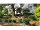 Charming house with mature landscaping, including colorful flowers and lush greenery at 3301 River Woods Dr, Parrish, FL 34219