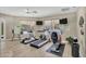 Community gym with exercise equipment, natural light, and hardwood floors at 3301 River Woods Dr, Parrish, FL 34219