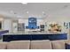 Modern kitchen boasts stainless steel appliances, a large island, and vibrant blue backsplash, perfect for culinary enthusiasts at 3301 River Woods Dr, Parrish, FL 34219