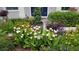 Landscaped front yard featuring beautiful flowering plants and other greenery enhancing the home's curb appeal at 3301 River Woods Dr, Parrish, FL 34219