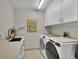 Well-lit laundry room features modern washer and dryer and sleek countertops at 3301 River Woods Dr, Parrish, FL 34219