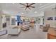 Bright open-plan living room boasts lots of natural light, tray ceilings, and modern decor at 3301 River Woods Dr, Parrish, FL 34219