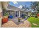 Brick patio with screened-in porch, lush landscaping and a view of the well-maintained lawn at 3301 River Woods Dr, Parrish, FL 34219