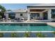 The outdoor area has a covered patio, a sparkling pool, and comfortable lounge furniture at 355 W Royal Flamingo Dr, Sarasota, FL 34236