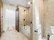 Well-lit bathroom with combination shower and soaking tub, modern fixtures, and neutral tile at 355 W Royal Flamingo Dr, Sarasota, FL 34236