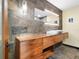 Stylish bathroom featuring a floating vanity, modern lighting, and a unique stone backsplash at 355 W Royal Flamingo Dr, Sarasota, FL 34236