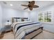 Cozy bedroom features a patterned rug, ceiling fan, and plantation shutters at 355 W Royal Flamingo Dr, Sarasota, FL 34236