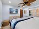 Bright bedroom with light blue walls, ceiling fan, neutral carpet and an art collection at 355 W Royal Flamingo Dr, Sarasota, FL 34236