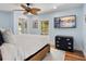 Comfortable bedroom with a ceiling fan, serene artwork, and a picturesque window view at 355 W Royal Flamingo Dr, Sarasota, FL 34236