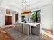 Bright dining room featuring a modern light fixture, table, and large window with lush views at 355 W Royal Flamingo Dr, Sarasota, FL 34236