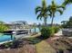 View of the dock with a boat lift, tropical landscaping and view of the waterway at 355 W Royal Flamingo Dr, Sarasota, FL 34236