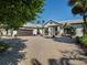 Elegant home features a paver driveway, two car garage, mature trees, and meticulous landscaping at 355 W Royal Flamingo Dr, Sarasota, FL 34236