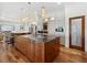 Bright kitchen with a large wooden island, modern stainless steel appliances, pendant lighting and tile flooring at 355 W Royal Flamingo Dr, Sarasota, FL 34236