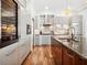 This sleek kitchen features modern gray cabinets, stainless steel appliances, and a granite-topped island with a sink at 355 W Royal Flamingo Dr, Sarasota, FL 34236