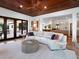 Open-concept living room with vaulted wood ceilings, a white sectional sofa, and a view of the modern kitchen at 355 W Royal Flamingo Dr, Sarasota, FL 34236