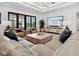 Bright living room featuring plush seating, a modern entertainment center, and water views at 355 W Royal Flamingo Dr, Sarasota, FL 34236