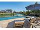 Lounge by the pool with waterfront views and a well-manicured landscape; perfect for outdoor relaxation at 355 W Royal Flamingo Dr, Sarasota, FL 34236