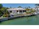 Beautiful waterfront home with a private pool, dock, and lush tropical landscaping at 355 W Royal Flamingo Dr, Sarasota, FL 34236