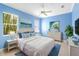 Inviting bedroom featuring a large window with abundant natural light, ceiling fan, and coastal decor at 4245 Corso Venetia Blvd, Venice, FL 34293