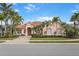 Inviting single-Gathering home with a red door and lush landscaping at 4245 Corso Venetia Blvd, Venice, FL 34293