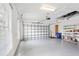 Spacious two car garage featuring an automatic door and built in shelving at 4245 Corso Venetia Blvd, Venice, FL 34293