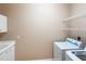 Neutral laundry room with washer, dryer, utility sink, and wire shelving at 4245 Corso Venetia Blvd, Venice, FL 34293