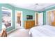 Main bedroom with private access to the pool, TV, and en-suite bathroom at 4245 Corso Venetia Blvd, Venice, FL 34293