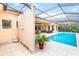 Screened-in pool area with lounge seating, dining area, and outdoor shower at 4245 Corso Venetia Blvd, Venice, FL 34293