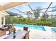 Screened-in pool and patio area surrounded by lush landscaping at 4245 Corso Venetia Blvd, Venice, FL 34293
