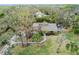 Aerial view of house nestled among mature trees and lush landscaping at 4931 Hidden Oaks Trl, Sarasota, FL 34232