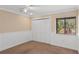 Neutral bedroom with ceiling fan, neutral carpet and large closet with paneled doors at 4931 Hidden Oaks Trl, Sarasota, FL 34232