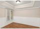 Cozy bedroom with wood floors, wainscotting and a window with privacy blinds at 4931 Hidden Oaks Trl, Sarasota, FL 34232