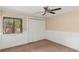 Neutral bedroom with ceiling fan, neutral carpet and large closet with paneled doors at 4931 Hidden Oaks Trl, Sarasota, FL 34232