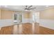 Spacious bedroom features hardwood floors, a ceiling fan, and French doors to the bathroom at 4931 Hidden Oaks Trl, Sarasota, FL 34232
