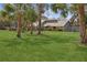 Well-maintained home featuring lush landscaping and a spacious front yard at 4931 Hidden Oaks Trl, Sarasota, FL 34232