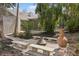 Beautiful outdoor fire pit area with concrete benches and lush landscaping at 4931 Hidden Oaks Trl, Sarasota, FL 34232